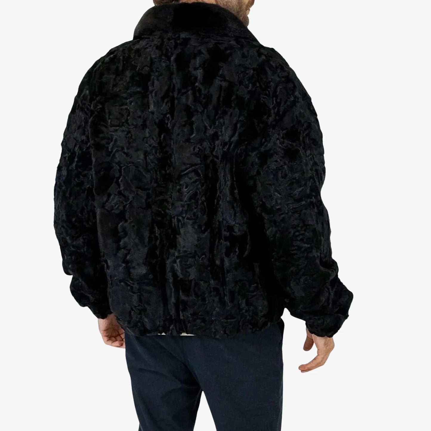 Black fur jacket worn by a person on a white background
