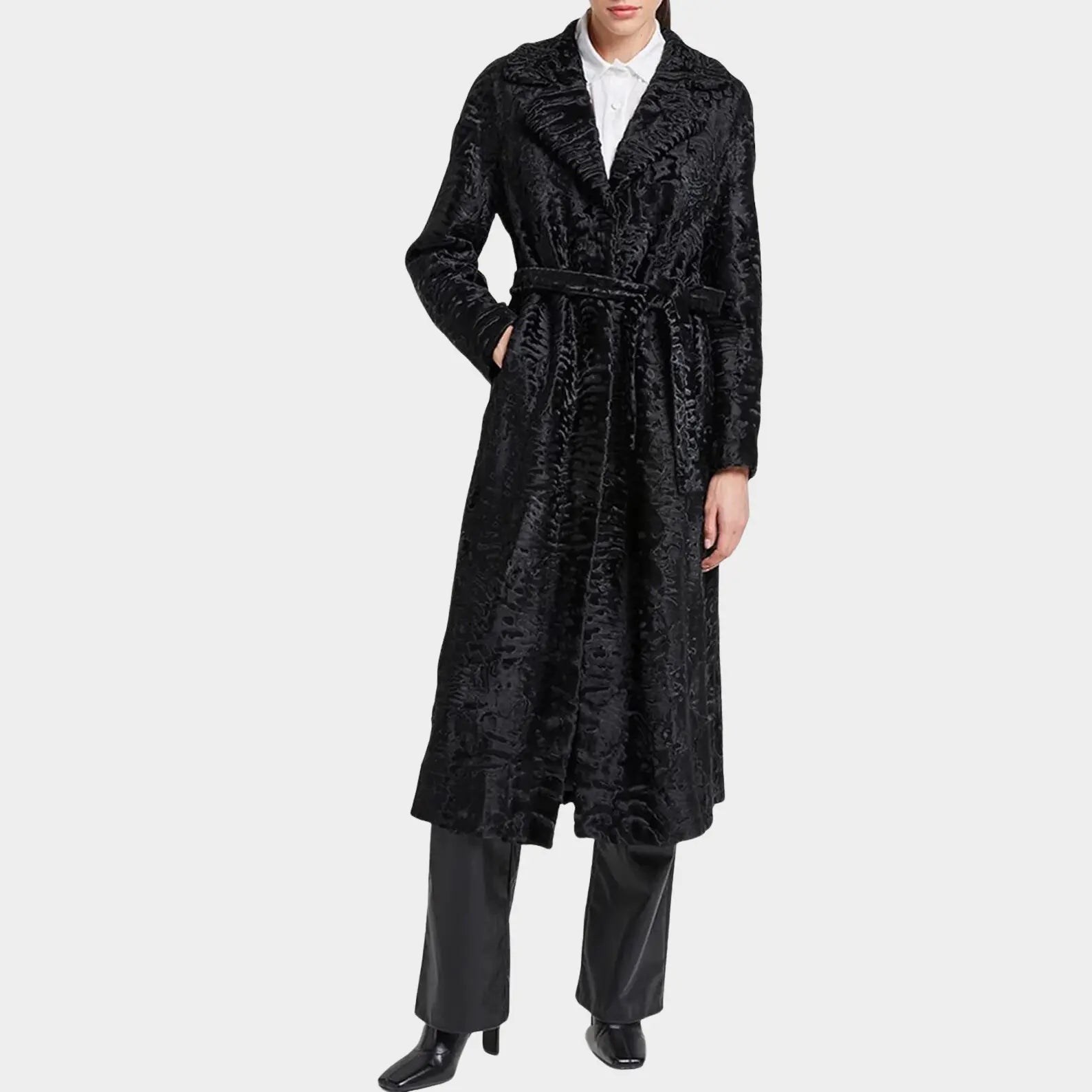 Person wearing a black textured coat on a white background