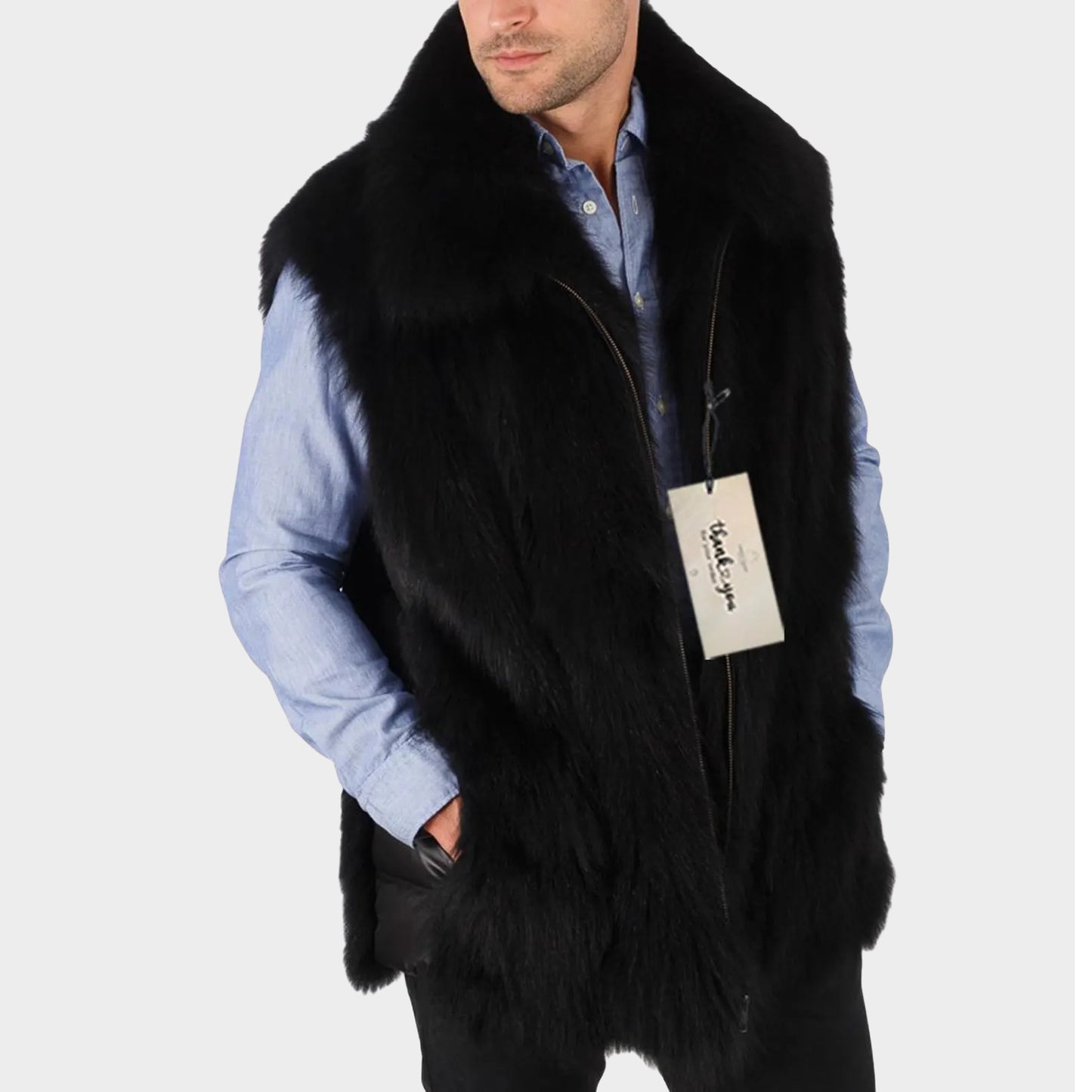 Man wearing a black fur vest over a blue shirt with a visible brand tag on a white background