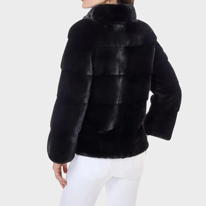 Black fur jacket worn by a person on a white background