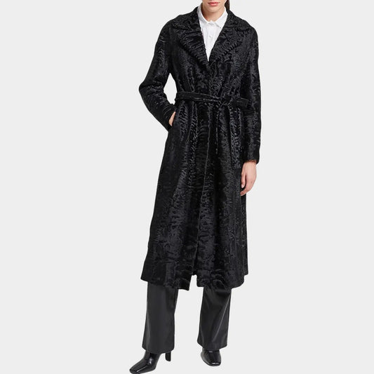 Person wearing a black textured coat on a white background