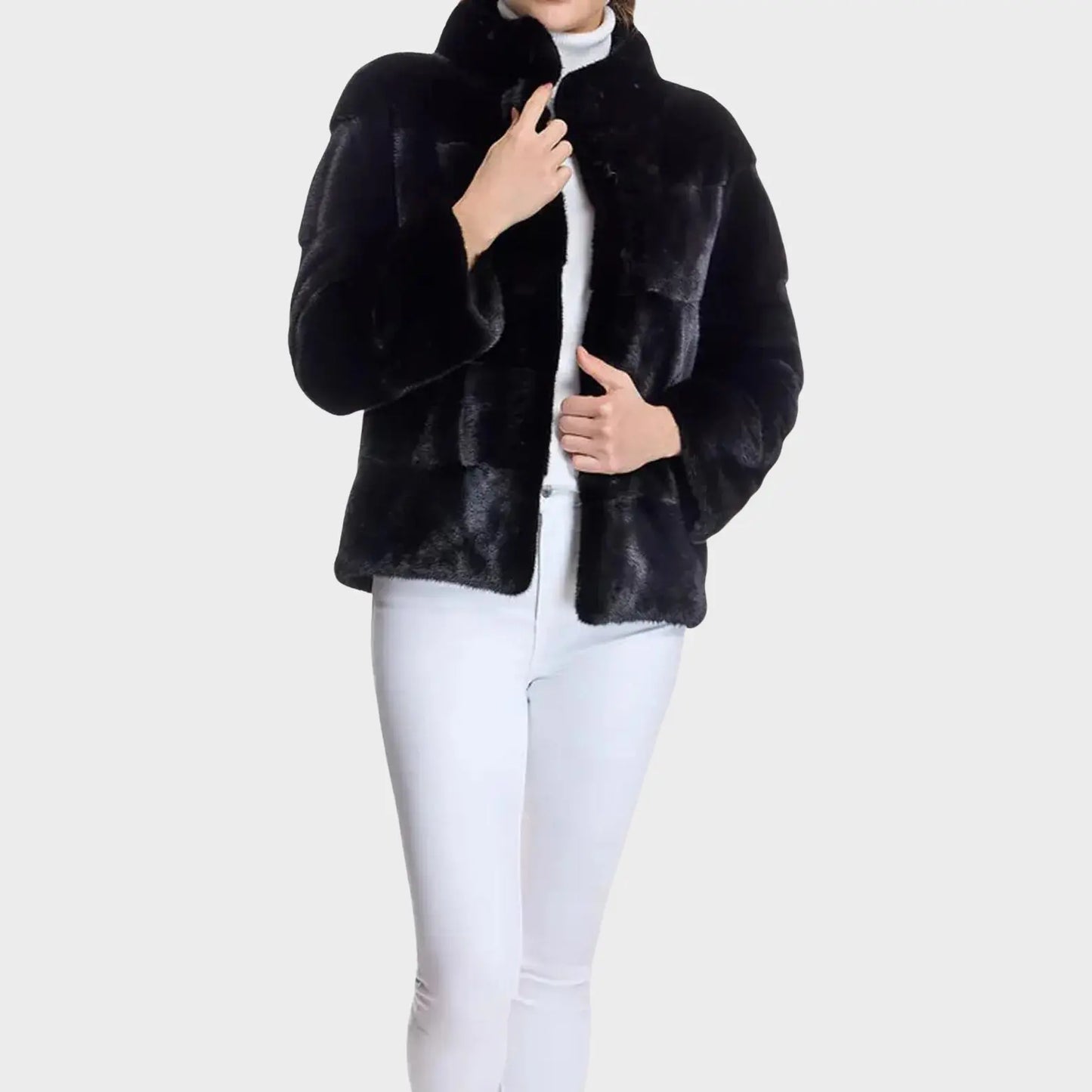 Black fur jacket worn by a person on a white background