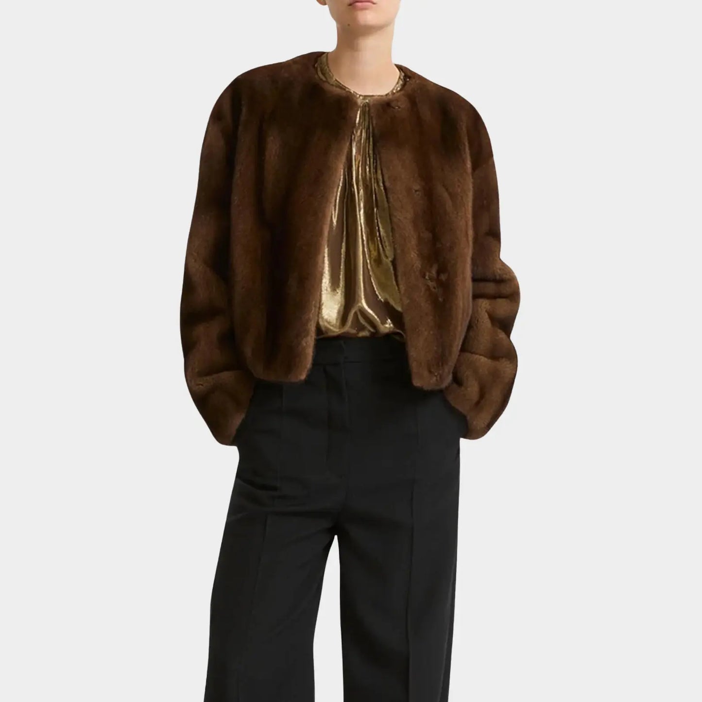 Brown fur jacket worn by a person on a white background