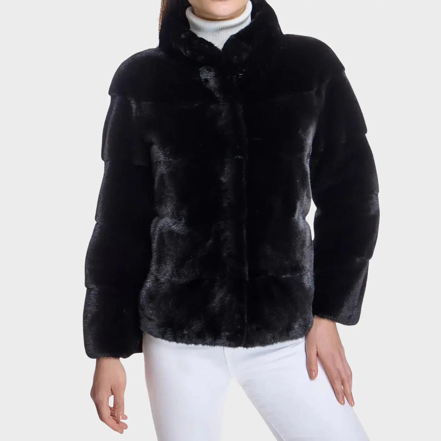 Black fur jacket worn by a person on a white background