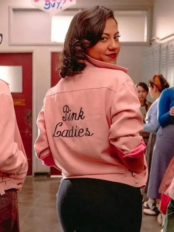 Person wearing a pink jacket with 'Pink Ladies' text in a school setting