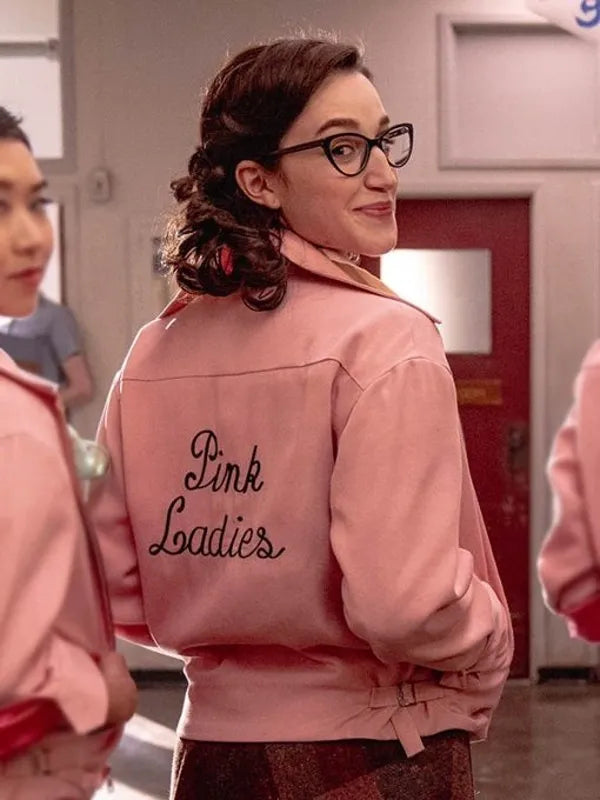 Person wearing a pink jacket with 'Pink Ladies' text in a casual setting