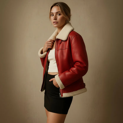 Woman wearing a red leather jacket with white fur lining against a beige background